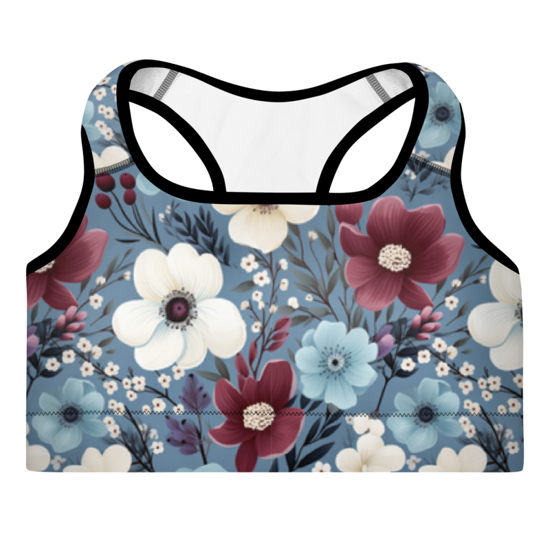 A sports bra with a butterfly garden print, predominantly blue with red and white flowers, and a scoop neckline.