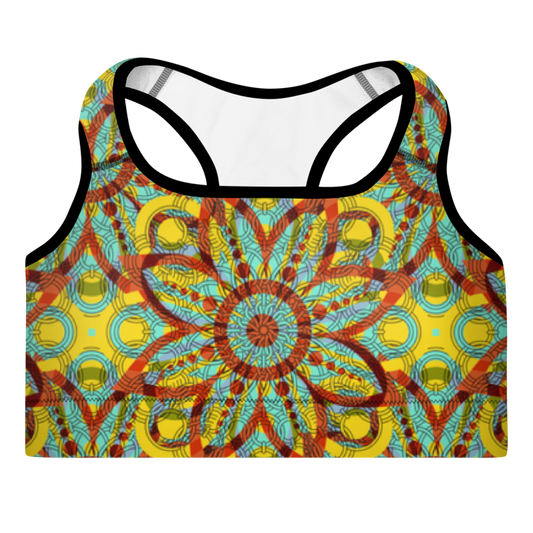 A sports bra with a kaleidoscope-like pattern in yellow, red, and blue colors, featuring a scoop neckline and wide shoulder straps.