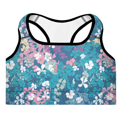 A sports bra with a multicolor floral pattern on a blue background, featuring adjustable straps and padding.