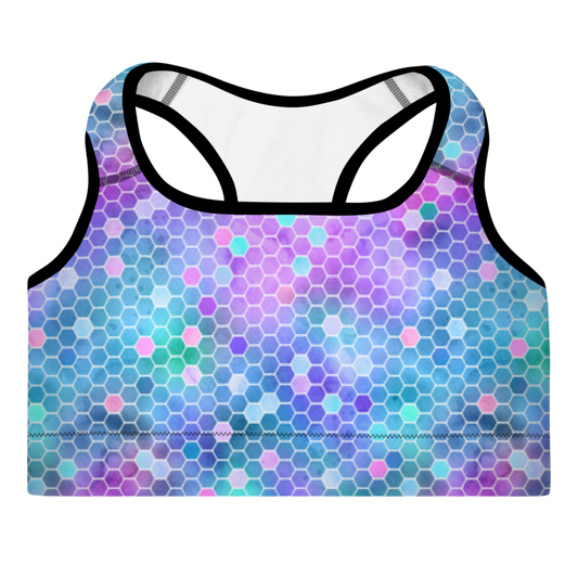 A sports bra with a honeycomb pattern in pink and purple colors, featuring a scoop neckline, racerback design, and shoulder straps.