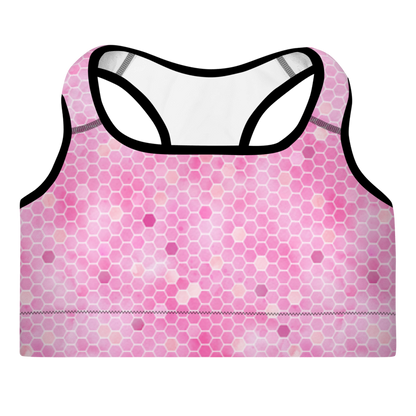 A pink sports bra with honeycomb pattern and shoulder straps, designed for workouts.