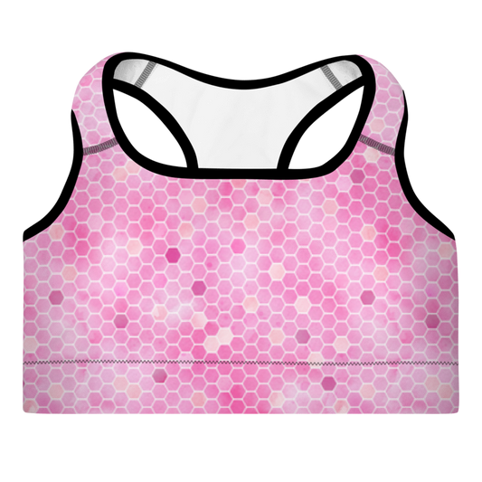 A pink sports bra with honeycomb pattern and shoulder straps, designed for workouts.