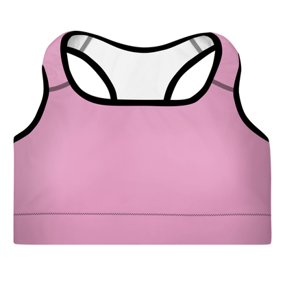 A pink sports bra with a scoop neckline, racerback design, and adjustable straps with support material in the shoulder straps. The material appears to be moisture-wicking and there is a visible brand logo.
