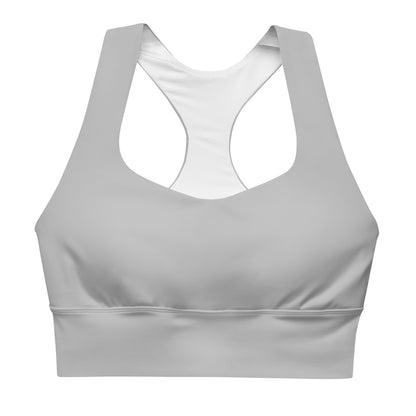 A longline sports bra in silver color with double-layered front and shoulder straps, and mesh lining.